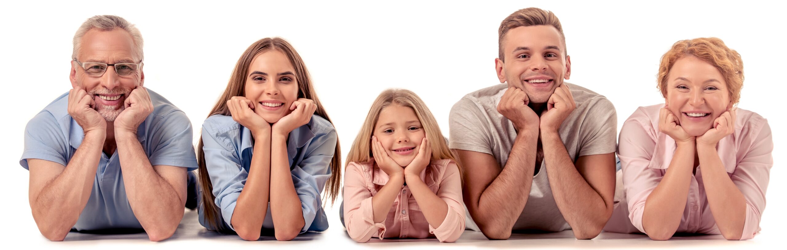 Lakeside smile Family Dentistry big happy family beautiful parents and grandparents leaning on their hands, looking at camera and smiling while lying on the floor