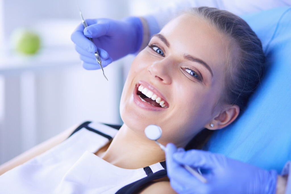 Lakeside smile Young Female patient with open mouth examining dental inspection at dentist office