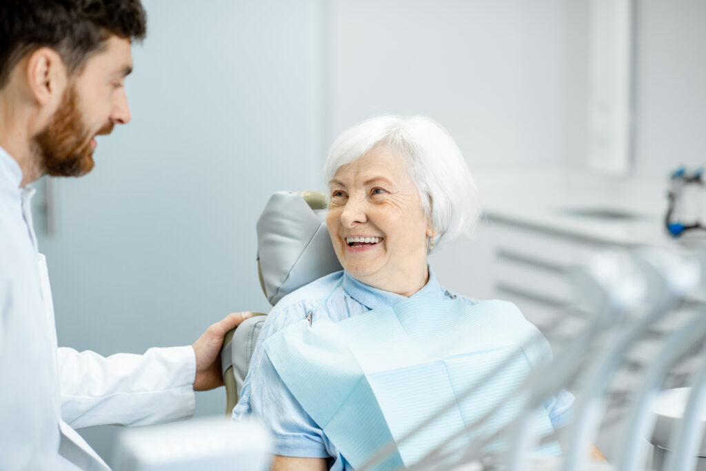 Lakeside smile Beautiful elder woman with healthy smile sitting during the consultation with dentist at the dental office