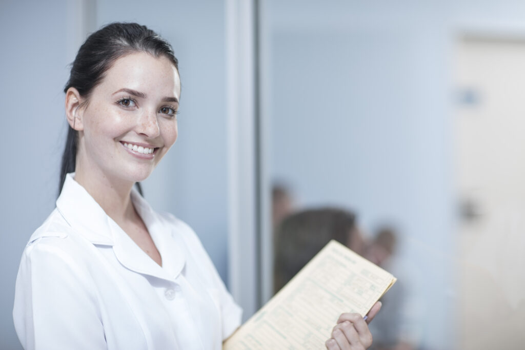 Lakeside smile Nurse holding patient's record, portrait