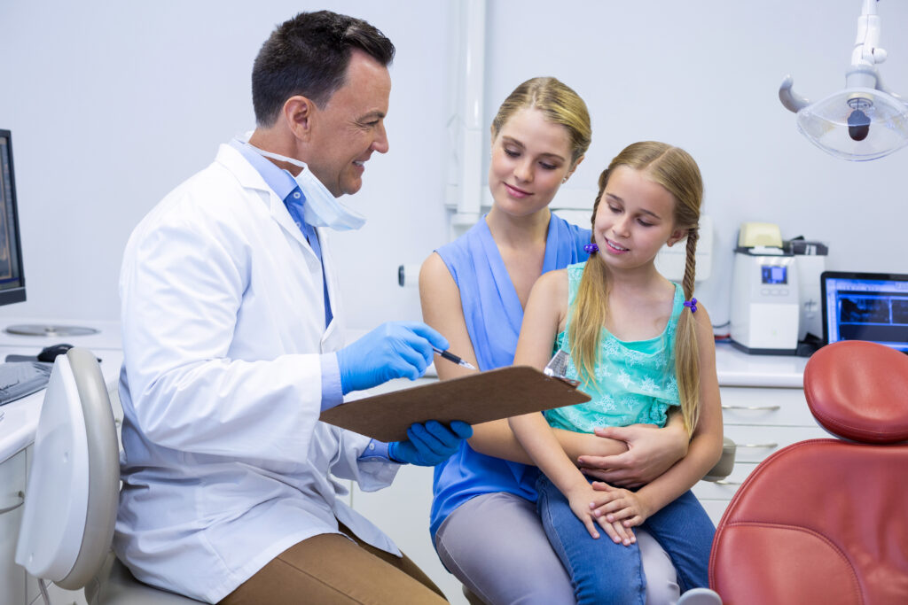 Lakeside smile Smiling dentists interacting with female patient at dental clinic