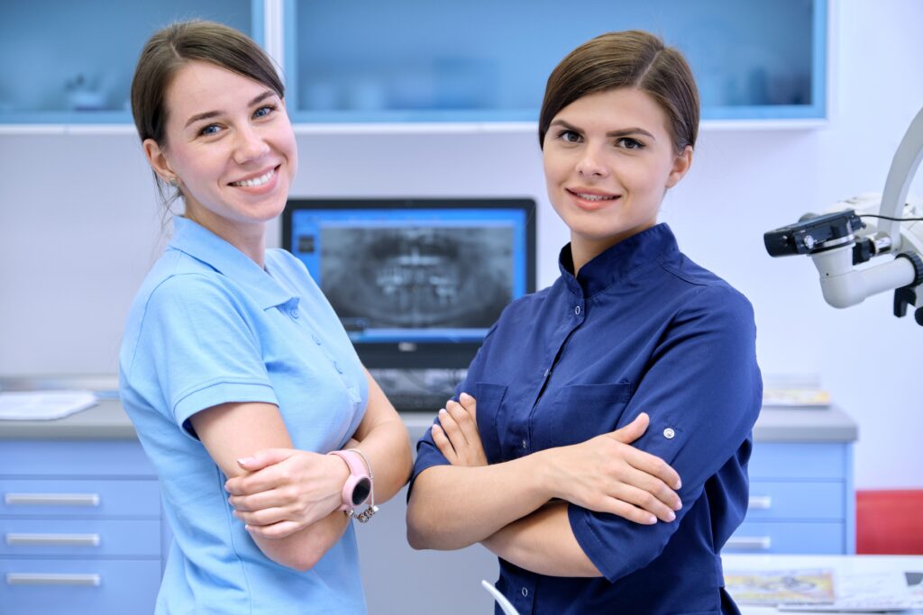 Lakeside smile Team of two doctors women dentists in the dental office, female colleagues look at camera. Medicine, dentistry and health care concept